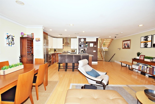 living room featuring crown molding and light hardwood / wood-style floors