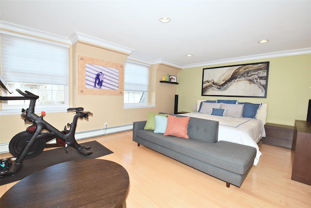 bedroom with crown molding, light wood-type flooring, and baseboard heating