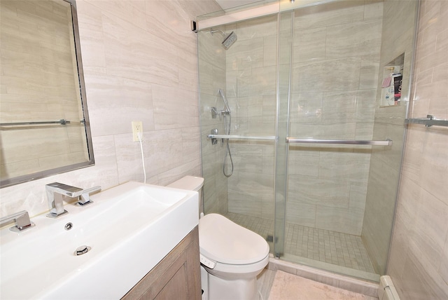 bathroom featuring tile walls, an enclosed shower, vanity, a baseboard radiator, and toilet