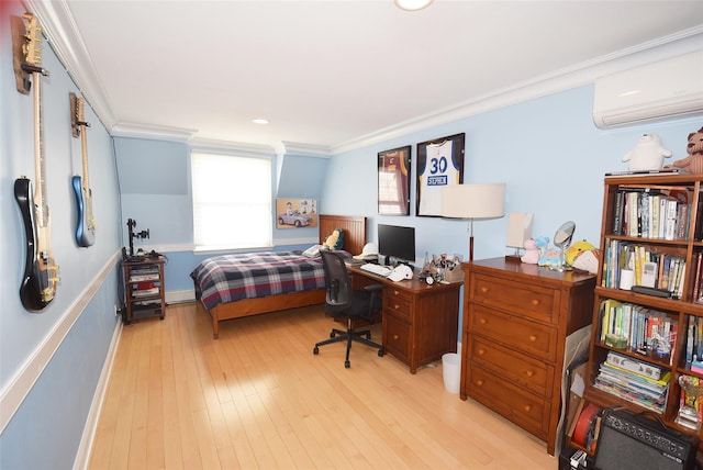 bedroom with crown molding, light hardwood / wood-style floors, and a wall mounted AC