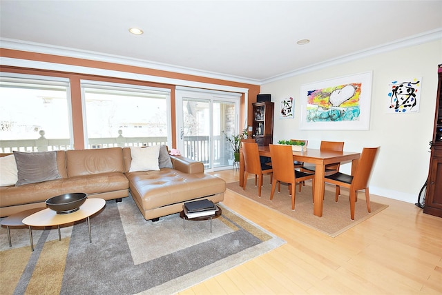 living room with ornamental molding and light hardwood / wood-style flooring