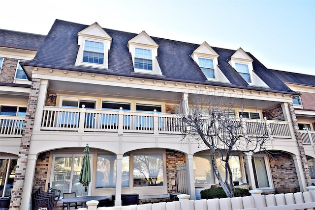 view of front of house featuring a balcony