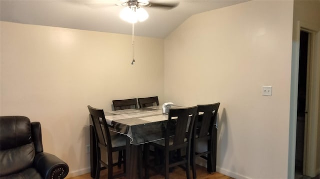 dining space featuring lofted ceiling, wood-type flooring, and ceiling fan