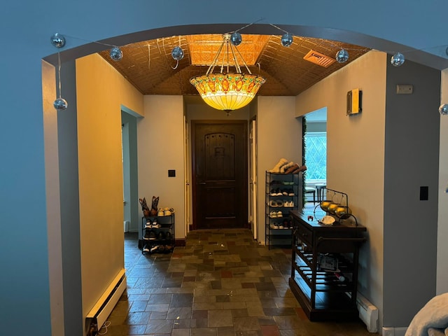 corridor featuring baseboard heating, brick ceiling, and lofted ceiling