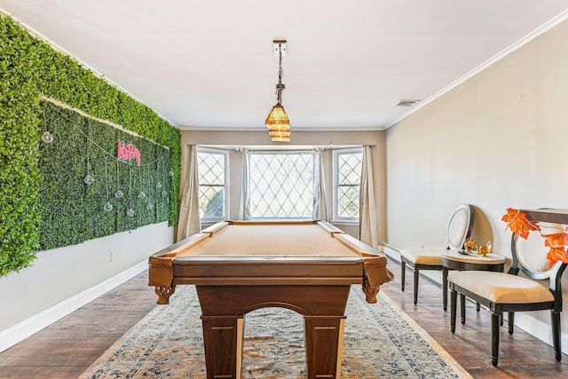 game room with baseboard heating, ornamental molding, and wood-type flooring