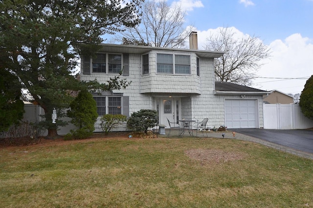 view of front facade featuring a garage and a front lawn