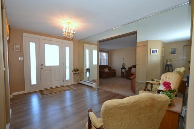 foyer featuring an inviting chandelier, dark hardwood / wood-style floors, and a baseboard heating unit