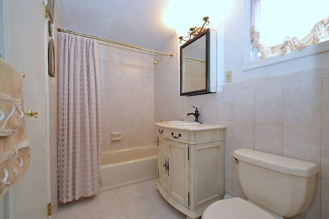 full bathroom featuring tile walls, tile patterned flooring, vanity, toilet, and shower / bath combo