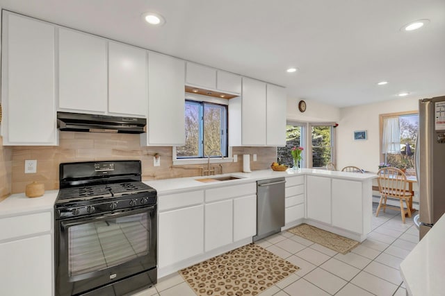 kitchen with stainless steel appliances, white cabinetry, sink, and light tile patterned floors