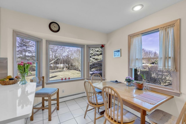 dining area featuring light tile patterned floors, plenty of natural light, and baseboard heating