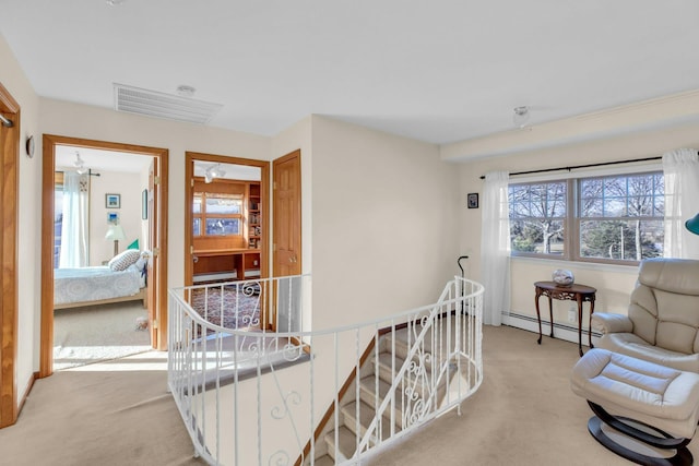 interior space featuring light carpet and baseboard heating