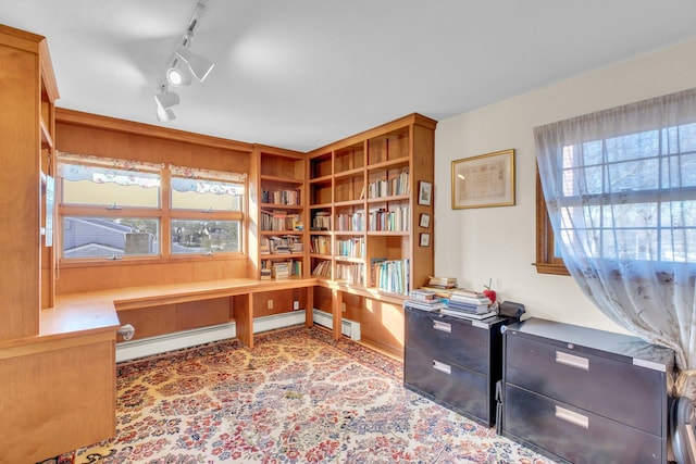 office area featuring built in desk and baseboard heating