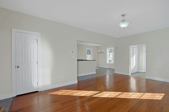 interior space featuring wood-type flooring and a chandelier