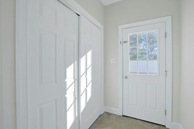 doorway to outside with light tile patterned floors