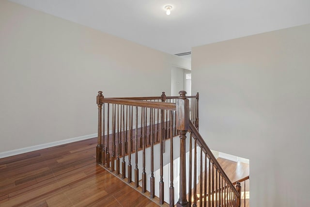 stairway featuring hardwood / wood-style floors