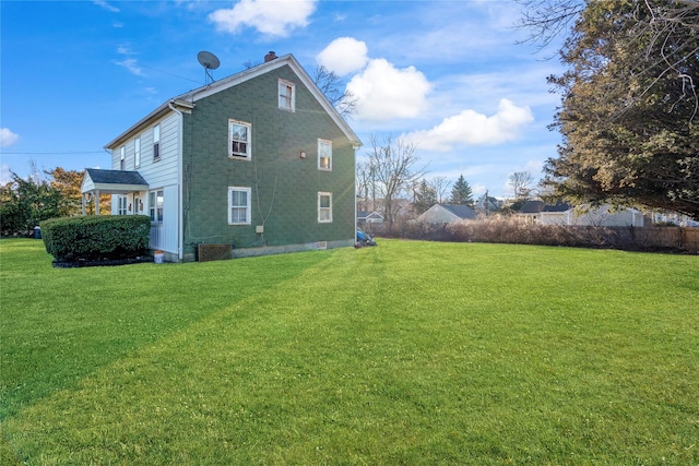 back of property featuring a yard