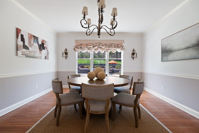 79 Victor Dr, Poughkeepsie, NY 12603 - dining area featuring baseboards, wood finished floors, an inviting chandelier, and crown molding