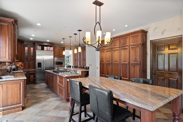 79 Victor Dr, Poughkeepsie, NY 12603 - kitchen with a sink, an island with sink, stainless steel appliances, a notable chandelier, and recessed lighting