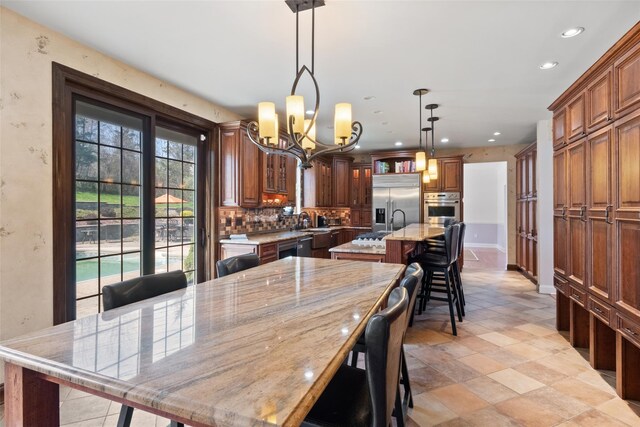 79 Victor Dr, Poughkeepsie, NY 12603 - dining room with baseboards, an inviting chandelier, recessed lighting, and stone finish flooring
