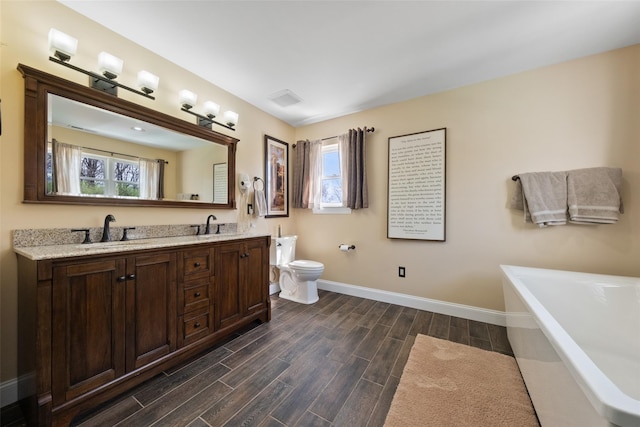 79 Victor Dr, Poughkeepsie, NY 12603 - bathroom featuring toilet, wood finished floors, a sink, and a bathing tub