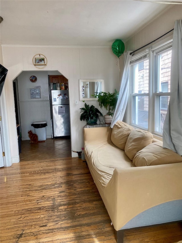 living room featuring crown molding and dark wood-type flooring