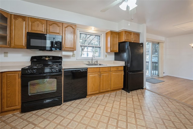 kitchen featuring sink, ceiling fan, and black appliances