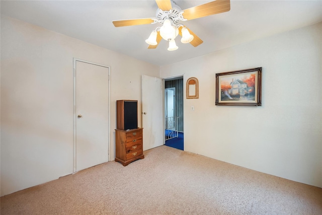 unfurnished bedroom with carpet flooring and ceiling fan