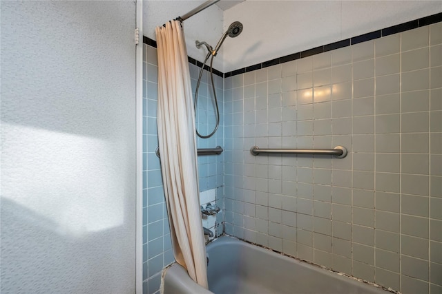 bathroom with shower / bathtub combination with curtain