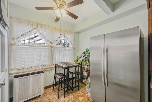 kitchen with radiator heating unit, stainless steel fridge, and ceiling fan