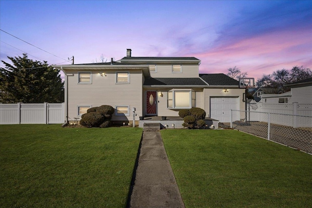 view of front of house featuring a yard and a garage