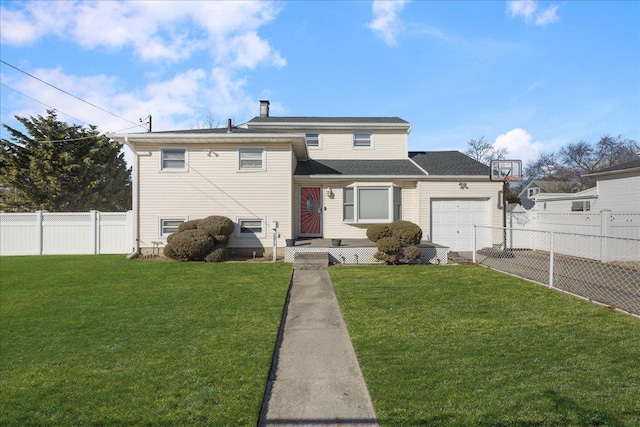 view of front of home featuring a garage and a front lawn