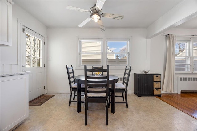 dining area with radiator and ceiling fan