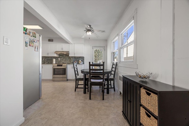 dining area with ceiling fan, radiator, and sink