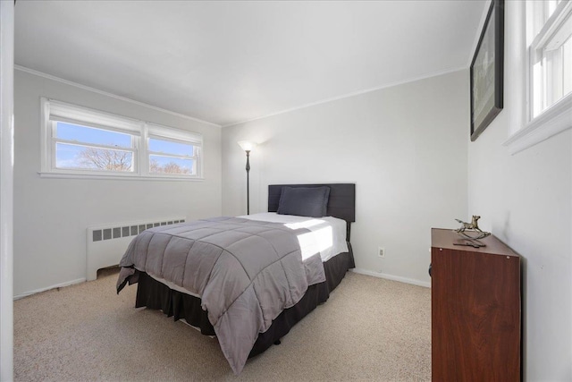 bedroom featuring multiple windows, radiator, and light colored carpet