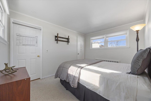 bedroom with crown molding, radiator, and light carpet