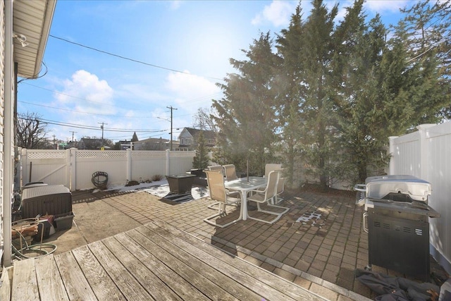 wooden deck with grilling area and a patio area