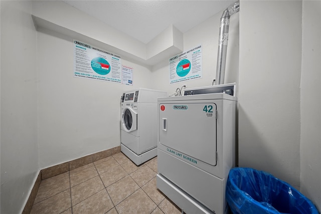 laundry room featuring light tile patterned floors and washing machine and dryer