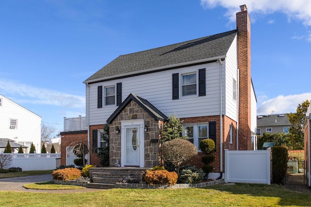 view of front of property with a front yard and a balcony