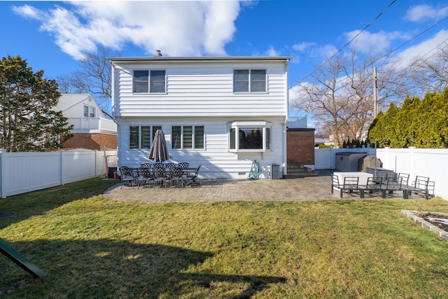 back of house featuring a patio and a yard