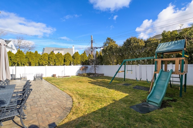 view of yard featuring a patio and a playground