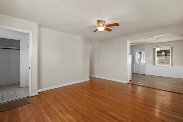 unfurnished living room featuring wood-type flooring and ceiling fan