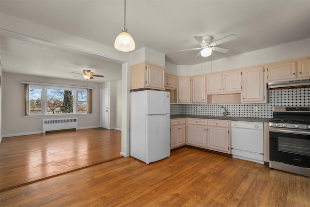 kitchen with white appliances, radiator heating unit, decorative backsplash, and hardwood / wood-style flooring