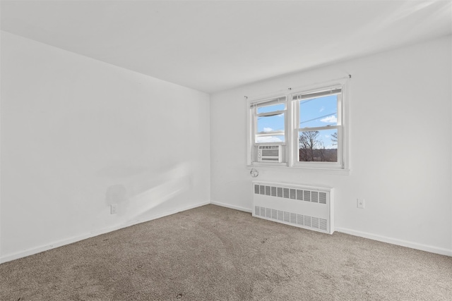 carpeted spare room with radiator and cooling unit