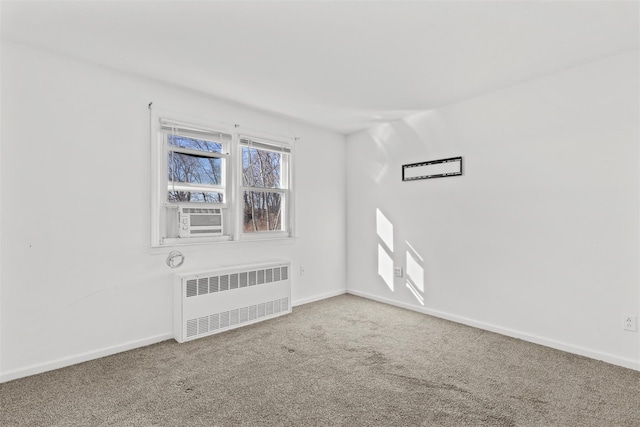 empty room featuring cooling unit, radiator heating unit, and carpet flooring