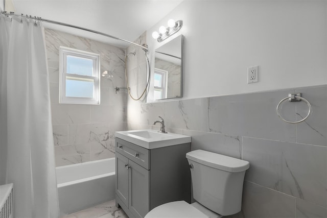 full bathroom featuring vanity, toilet, tile walls, and shower / bath combo