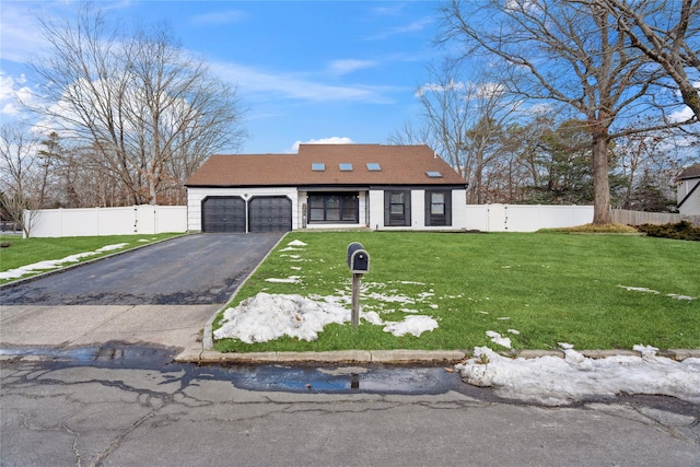 view of front of house featuring a garage and a front lawn