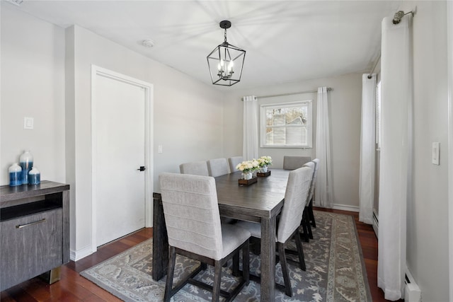 dining area with dark hardwood / wood-style floors, a chandelier, and baseboard heating