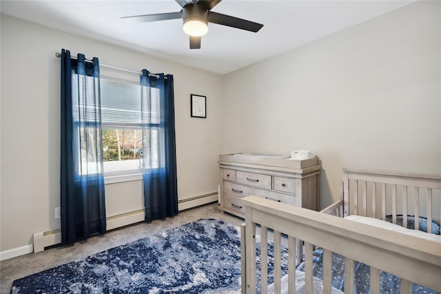 carpeted bedroom with a baseboard heating unit and ceiling fan