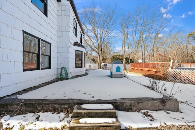 yard layered in snow with a wooden deck