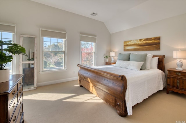 carpeted bedroom featuring lofted ceiling